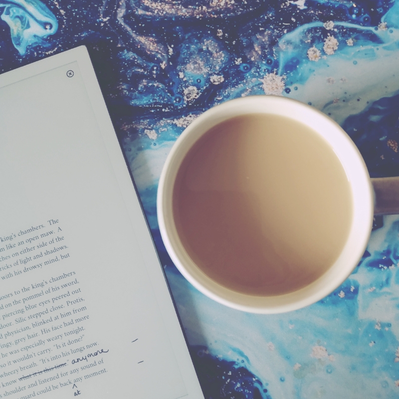 Writing tablet on top of several open books